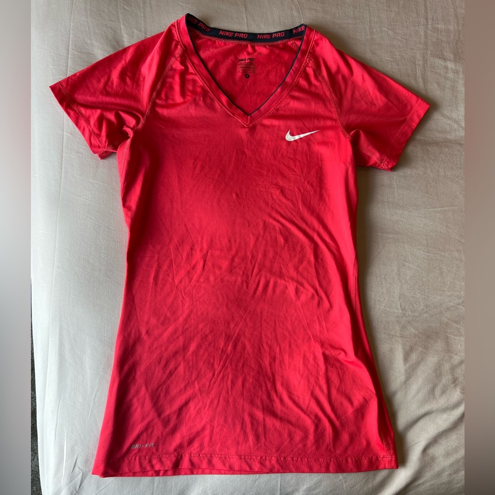 Nike small salmon colored athletic shirt.